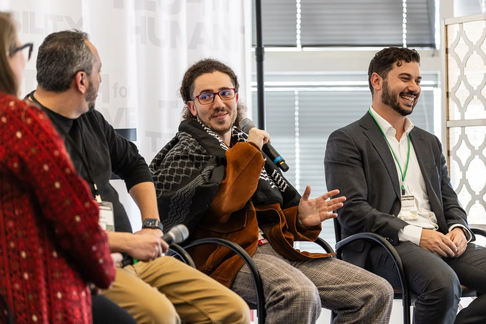 Panelists in conversation on stage at a Tech for Palestine gathering